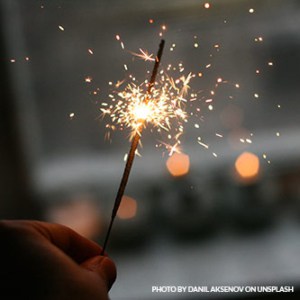 guy holding sparkler in his hand