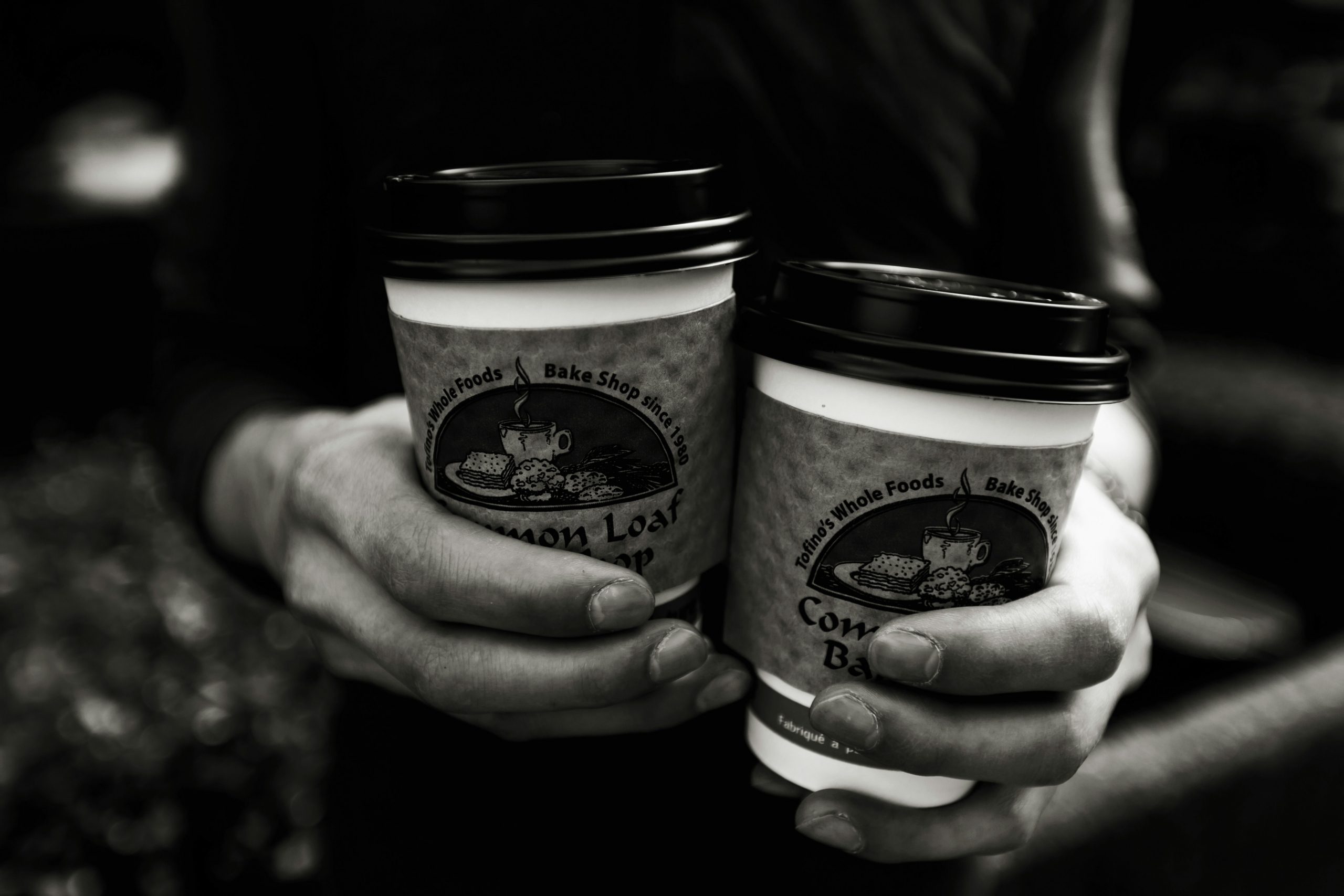 Two people holding coffee cups, ready for a conversation